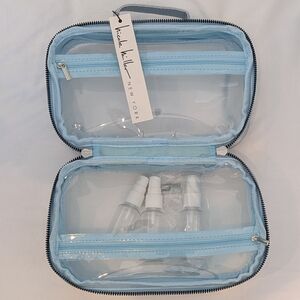 Blue and silver Nicole Miller travel case with clear interior, 3 spray bottles